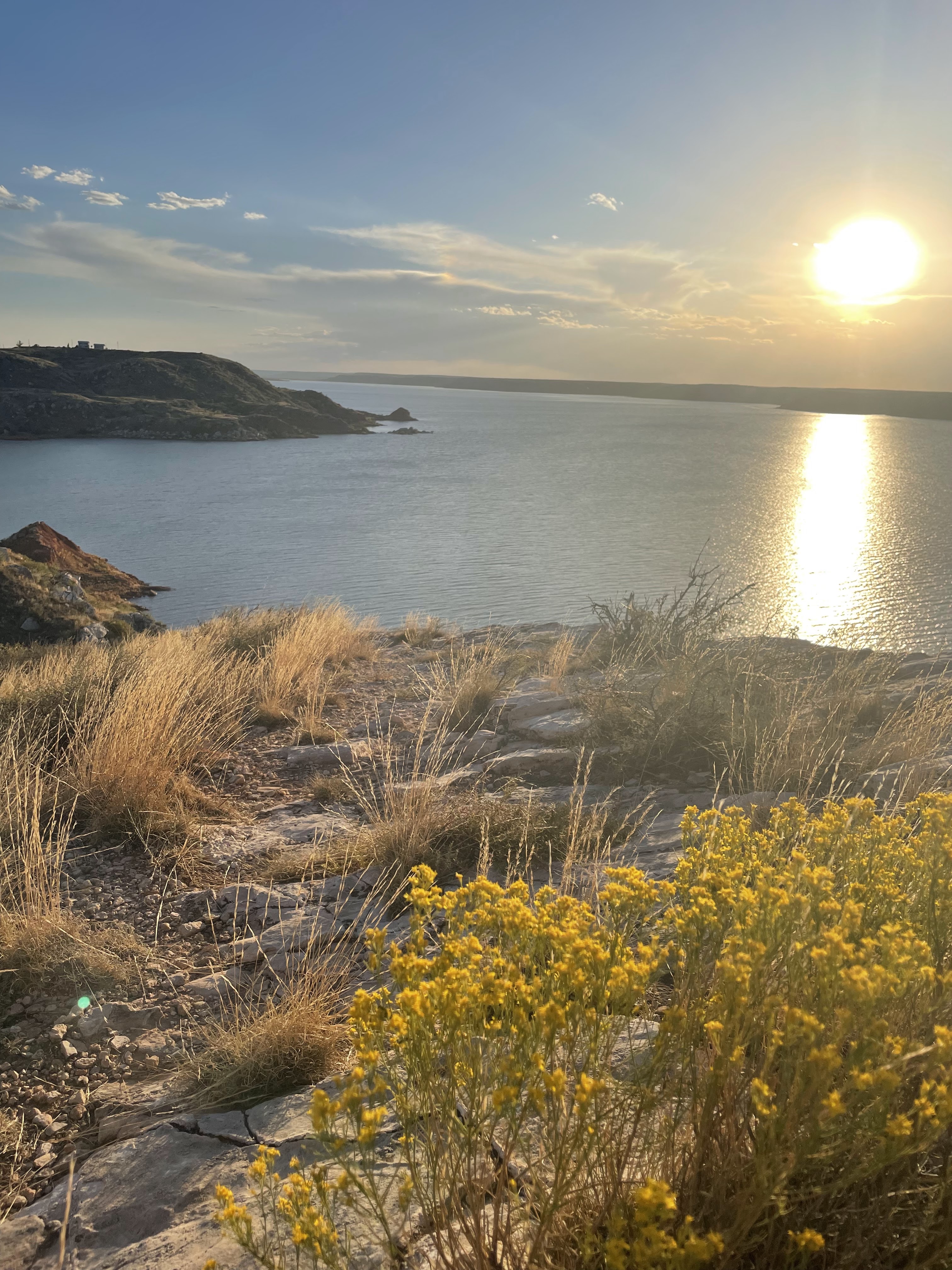 Low evening sun across Lake Meredith and its rocky shore